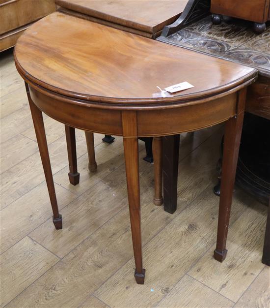 A George III style inlaid mahogany D shaped folding tea table W.80cm